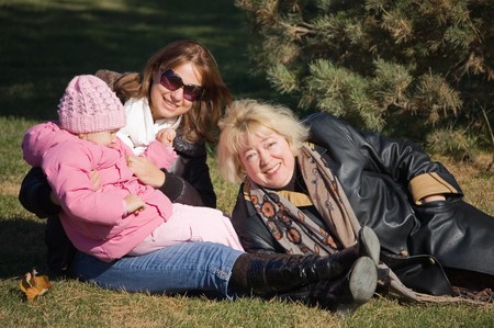 Happy family in autumn parkの写真素材
