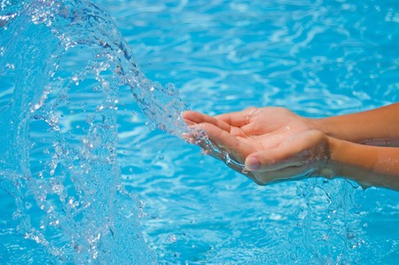 Female hands and water splashesの写真素材