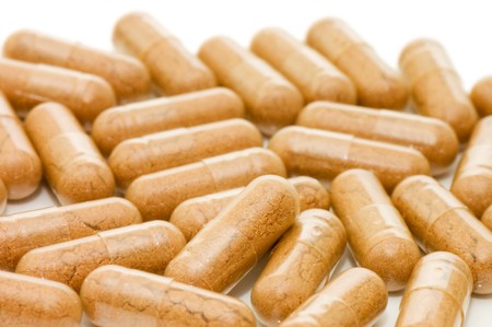 Heap of pills isolated on white backgroundの写真素材