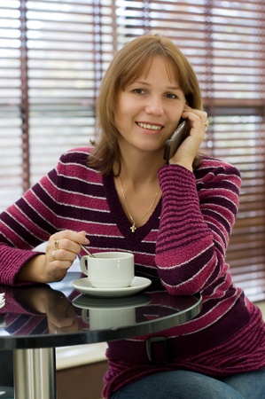 The girl talks by a mobile phoneの写真素材