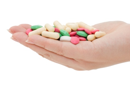 Hand with a pill on white backgroundの写真素材