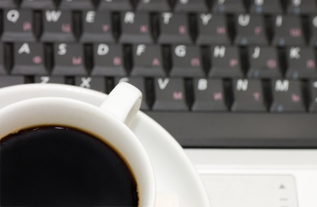 Cup from coffee on the laptopの写真素材