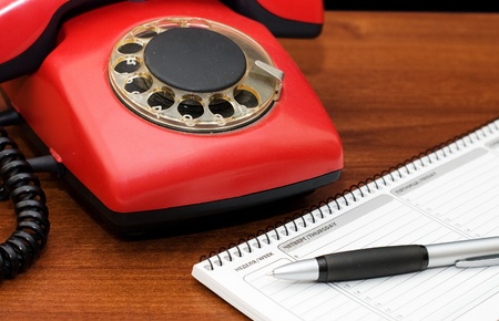 Red phone on a wooden tableの写真素材