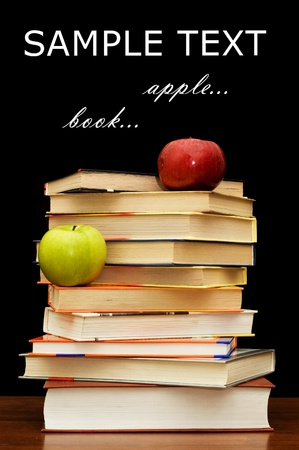 Stack of books and apple On a black backgroundの写真素材