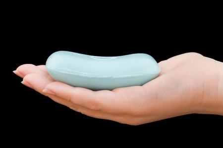 Soap in hand isolated on black background の写真素材