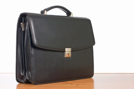 Fashionable leather briefcase on a tableの写真素材