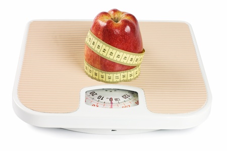 Scale, tape and apple on whiteの写真素材