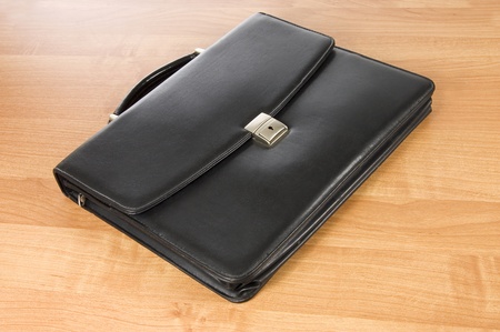 Fashionable leather briefcase on a tableの写真素材
