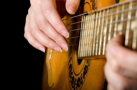 The woman plays an acoustic guitarの写真素材