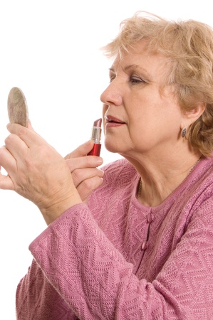 The elderly woman does a make-upの写真素材