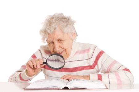 The elderly woman reads the bookの写真素材