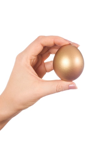 golden egg in the hand isolatedの写真素材