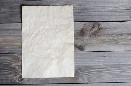 Old paper on a wooden surfaceの写真素材