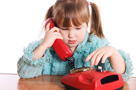 The little girl speaks by phone isolatedの写真素材