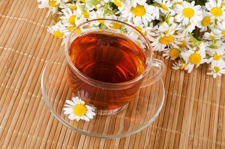 Glass cup with fragrant a camomile teaの写真素材