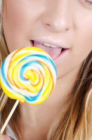 The girl with a sugar candy isolatedの写真素材
