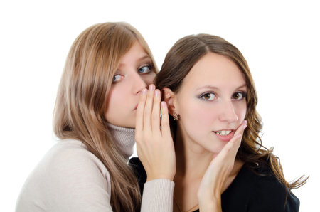 Two girl-friends tell gossips on an ear
