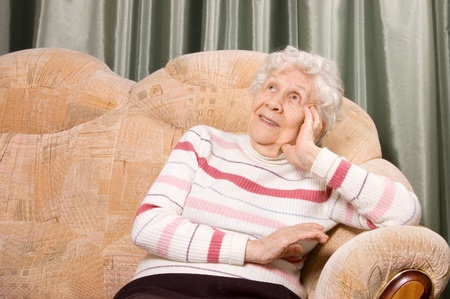 Portrait of the old woman on sofaの写真素材