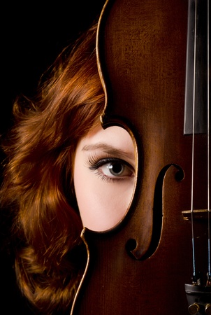 Beautiful girl with a violin on blackの写真素材
