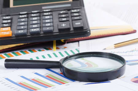 Business diagramme with magnifying glass, workplace businessmanの写真素材