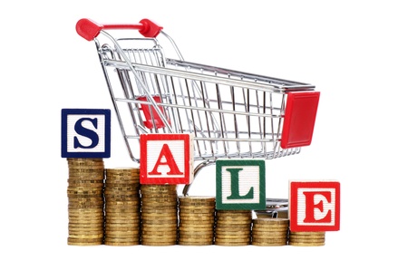 Coins in the form of the diagramme, shopping cart and word SALEの写真素材