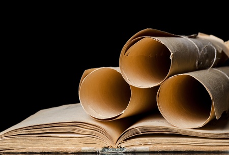 Many ancient scrolls and books on blackの写真素材