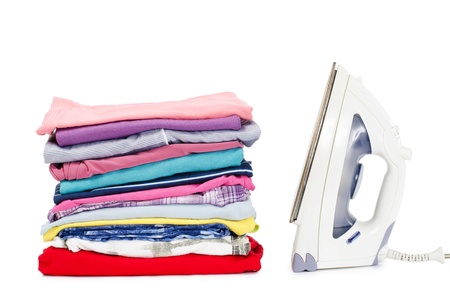 Heap of pure clothes with an ironの写真素材