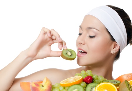 The beautiful woman with a fruit isolatedの写真素材