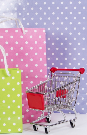 Shopping cart and bags isolated on whiteの写真素材