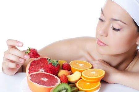 The beautiful woman with a fruit isolatedの写真素材