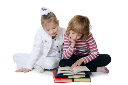 Two girls read book isolated on whiteの写真素材