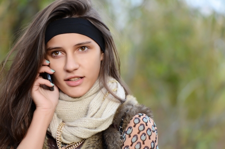 The girl speaks by phone in autumnの写真素材