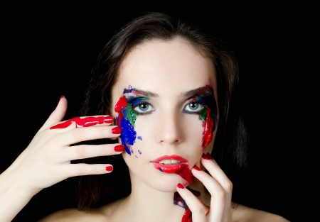 Beautiful woman with a paint on faceの写真素材