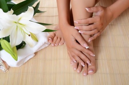 Woman hand and feet with manicure and Lily Woman hand and feet with manicure and Lily