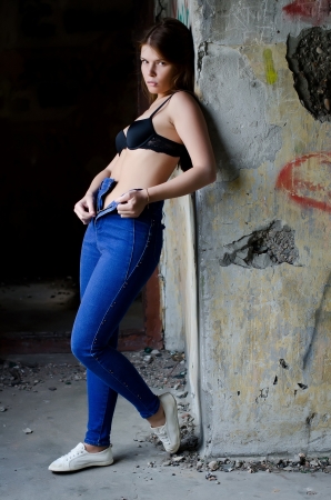 The girl against the destroyed old wallの写真素材