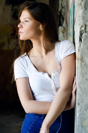 The girl against the destroyed old wallの写真素材