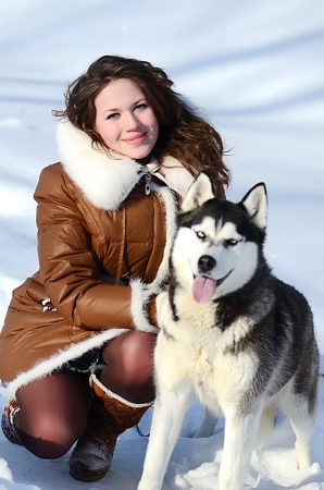 Woman with dog Husky in the winterの写真素材