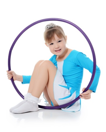 Little girl gymnast does exercise with hoopの写真素材