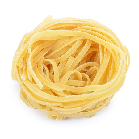Italian pasta tagliatelle nest isolated on whiteの写真素材
