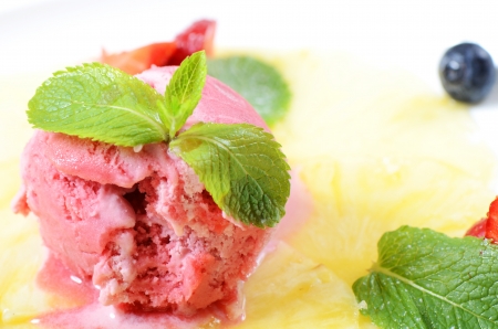Strawberry ice-cream with pineapples and mint close upの写真素材