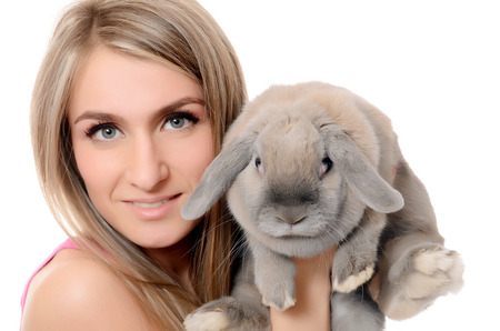 The beautiful woman with a grey rabbit isolatedの写真素材