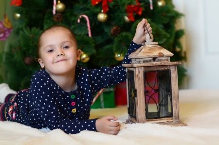 The little girl at a christmas fur-treeの写真素材