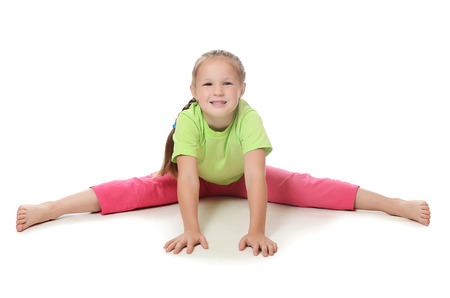 Little girl in sportswear isolated on whiteの写真素材