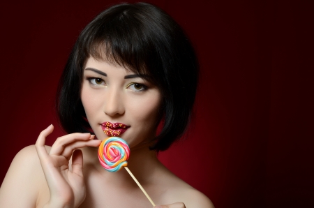 The beautiful  girl with a sugar candyの写真素材