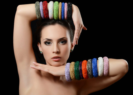 The beautiful woman in a multi-coloured bracelet