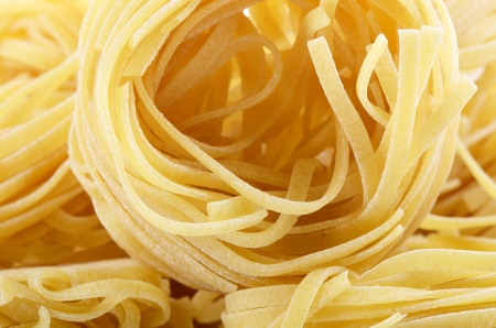 Uncooked pasta spaghetti macaroni as a backgroundの写真素材