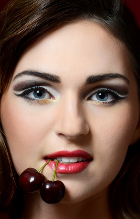 The beautiful woman with a sweet cherryの写真素材