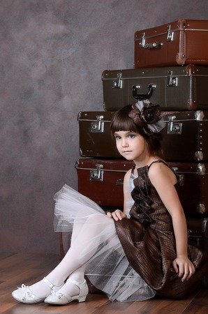 The little girl with old retro suitcasesの写真素材