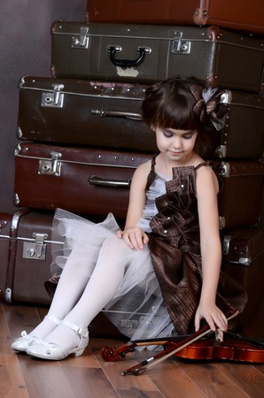 The little girl with old retro suitcasesの写真素材