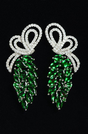 Silver earrings with jewels on the blackの写真素材